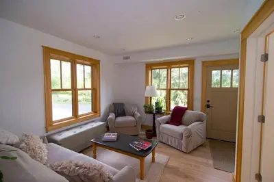 a living room with a couch and chairs and a table at Too Good AKA 2 Goodrich St in Stockbridge