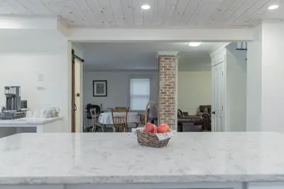 a kitchen with a basket of fruit on a counter at Restored 1881 Farm House in Lenox