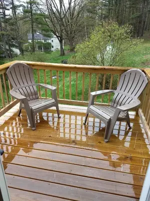 two chairs sitting on top of a wooden deck at Restored 1881 Farm House in Lenox