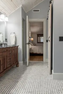a bathroom with a sink and a bedroom at Restored 1881 Farm House in Lenox