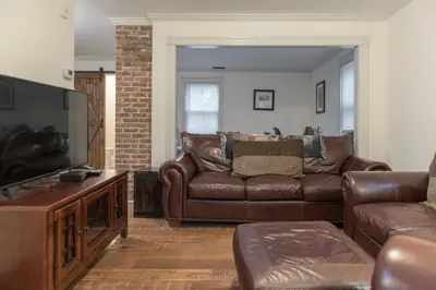 a living room with a couch and a television at Restored 1881 Farm House in Lenox