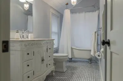 a bathroom with a sink and a toilet and a tub at Restored 1881 Farm House in Lenox