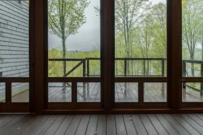 an empty room with a window looking out at a river at Private Home Overlooking Stevens Lake in Great Barrington