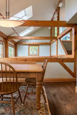 a dining room with a wooden table and chairs at Private Home Overlooking Stevens Lake in Great Barrington