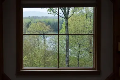 a window with a view of the woods at Private Home Overlooking Stevens Lake in Great Barrington