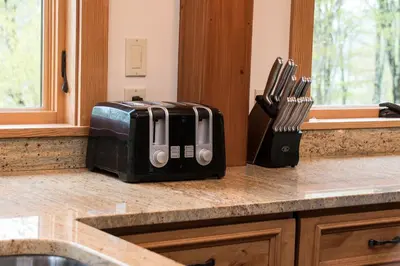 a kitchen counter with a toaster and knives on it at Private Home Overlooking Stevens Lake in Great Barrington