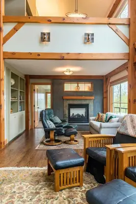 a living room filled with furniture and a fireplace at Private Home Overlooking Stevens Lake in Great Barrington