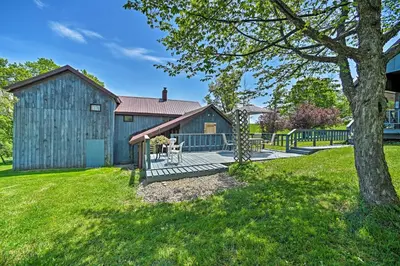 a large blue barn with a wooden deck at Country Escape with Sauna, 10 Mi to Cooperstown in Richfield Springs