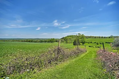 a path through a field with a fence at Country Escape with Sauna, 10 Mi to Cooperstown in Richfield Springs