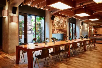 a long wooden table with chairs in a room at Ace Hotel Brooklyn in Brooklyn