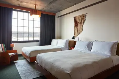 a hotel room with two beds and a window at Ace Hotel Brooklyn in Brooklyn