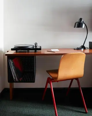 a wooden desk with a chair and a lamp at Ace Hotel Brooklyn in Brooklyn