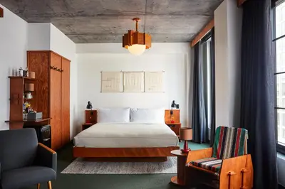 a hotel room with a bed and a chair at Ace Hotel Brooklyn in Brooklyn