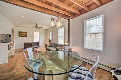 a dining room with a glass table and chairs at Charming Cottage with Yard - 2 Mi to Tinker St! in Woodstock