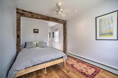a bedroom with a bed and a ceiling fan at Charming Cottage with Yard - 2 Mi to Tinker St! in Woodstock