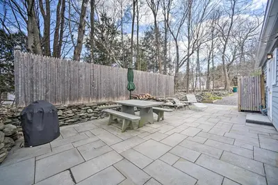 a patio with a picnic table and a fence at Charming Cottage with Yard - 2 Mi to Tinker St! in Woodstock