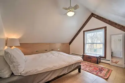 a bedroom with a bed and a ceiling fan at Charming Cottage with Yard - 2 Mi to Tinker St! in Woodstock