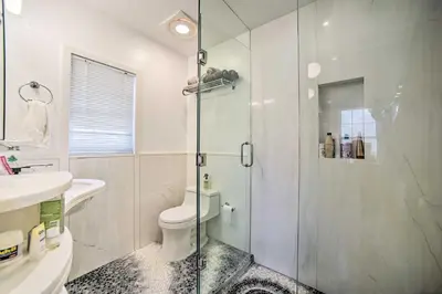 a bathroom with a shower and a toilet and a sink at Charming Cottage with Yard - 2 Mi to Tinker St! in Woodstock