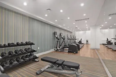 a gym with several treadmills and cardio machines at Hotel 1200 in Brooklyn