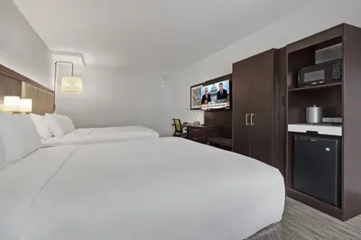 a hotel room with a large bed and a tv at Hotel 1200 in Brooklyn