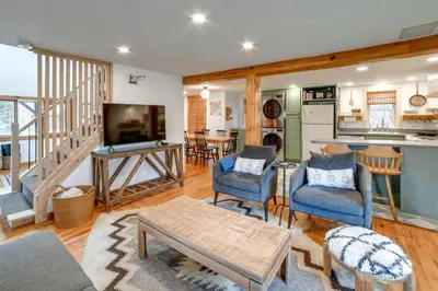 a living room with blue chairs and a kitchen at Hilltop Walton Getaway with Picturesque Views! in Walton