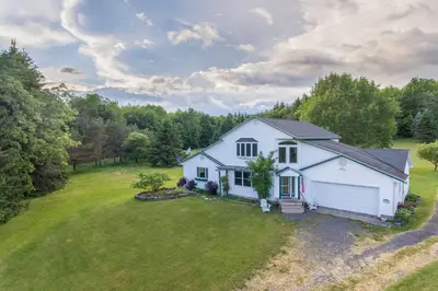 an aerial view of a white house with a yard at Burlington Flats House Less Than 13 Mi to Cooperstown! in Fly Creek