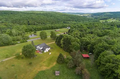 an aerial view of a house in the middle of a field at Burlington Flats House Less Than 13 Mi to Cooperstown! in Fly Creek