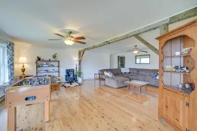 a living room with a couch and a table at Burlington Flats House Less Than 13 Mi to Cooperstown! in Fly Creek