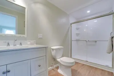 a white bathroom with a toilet and a shower at Burlington Flats House Less Than 13 Mi to Cooperstown! in Fly Creek