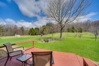 a deck with two chairs and a field of grass at Burlington Flats House Less Than 13 Mi to Cooperstown! in Fly Creek