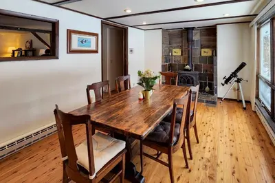 a dining room with a wooden table and chairs at Burlington Flats House Less Than 13 Mi to Cooperstown! in Fly Creek
