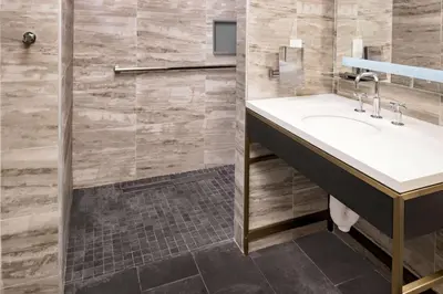 a bathroom with a sink and a shower at Hilton Club The Central at 5th New York in New York