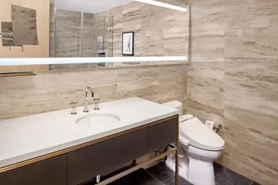a bathroom with a sink and a toilet at Hilton Club The Central at 5th New York in New York