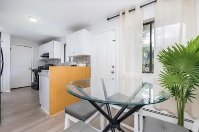 a kitchen and dining room with a glass table at Beautiful 3 bedroom Condo in Hartford! in Hartford