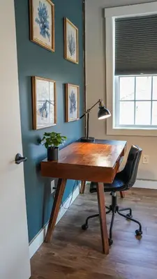 a desk with a lamp and a chair in a room at Old Mill Inn in Hatfield