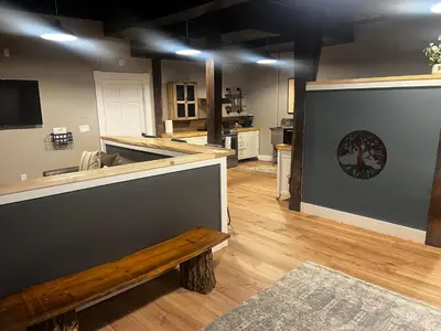 a large kitchen with a wooden counter and a bench at Old Mill Inn in Hatfield
