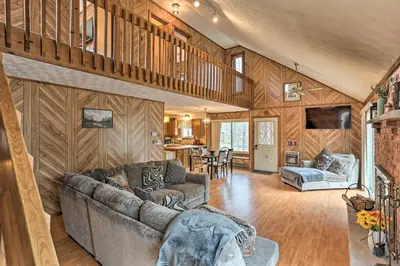 a living room with a couch and a table at Resort Perks Picturesque Poconos Getaway! in Bushkill