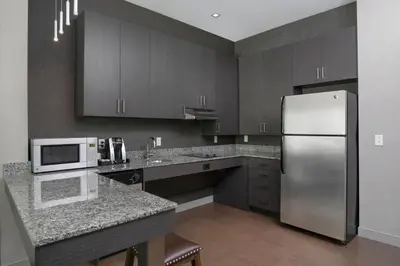 a kitchen with a stainless steel refrigerator and cabinets at Residence Inn by Marriott Orangeburg in Orangeburg