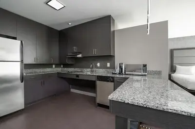 a kitchen with a stainless steel refrigerator and cabinets at Residence Inn by Marriott Orangeburg in Orangeburg