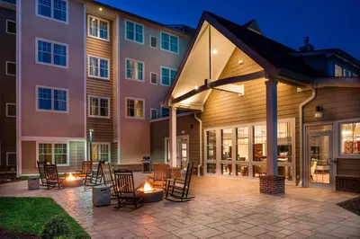 a patio with chairs and tables in front of a building at Residence Inn by Marriott Orangeburg in Orangeburg