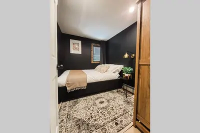 a bedroom with a bed with black walls at Pinewood Lodge - Catskills, Windham Mountain, Hunter Mountain in Catskill