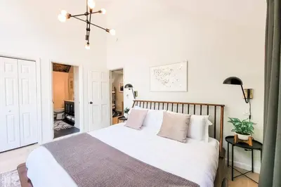a bedroom with a bed with white sheets and pillows at Pinewood Lodge - Catskills, Windham Mountain, Hunter Mountain in Catskill