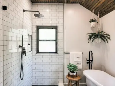a bathroom with white tiles and a shower with a tub at Pinewood Lodge - Catskills, Windham Mountain, Hunter Mountain in Catskill