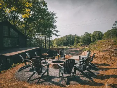 a group of chairs and tables sitting on a hill at Pinewood Lodge - Catskills, Windham Mountain, Hunter Mountain in Catskill