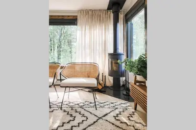 a living room with a chair and a stove at Pinewood Lodge - Catskills, Windham Mountain, Hunter Mountain in Catskill