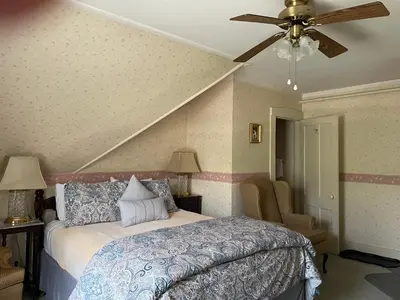 a bedroom with a bed and a ceiling fan at Deerfield Valley Inn - Mt Snow BnB Fireplace Rooms and Breakfast in Dover