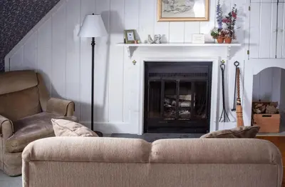 a living room with a couch and a fireplace at Deerfield Valley Inn - Mt Snow BnB Fireplace Rooms and Breakfast in Dover