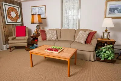 a living room with a couch and a coffee table at Deerfield Valley Inn - Mt Snow BnB Fireplace Rooms and Breakfast in Dover
