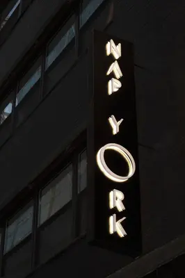 a sign for a hotel on the side of a building at Nap York Central Park Sleep Station in New York