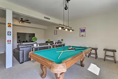 a living room with a pool table and a couch at New ! Slopeside Townhome : WFH, Ski, Dine & Hike in Tannersville